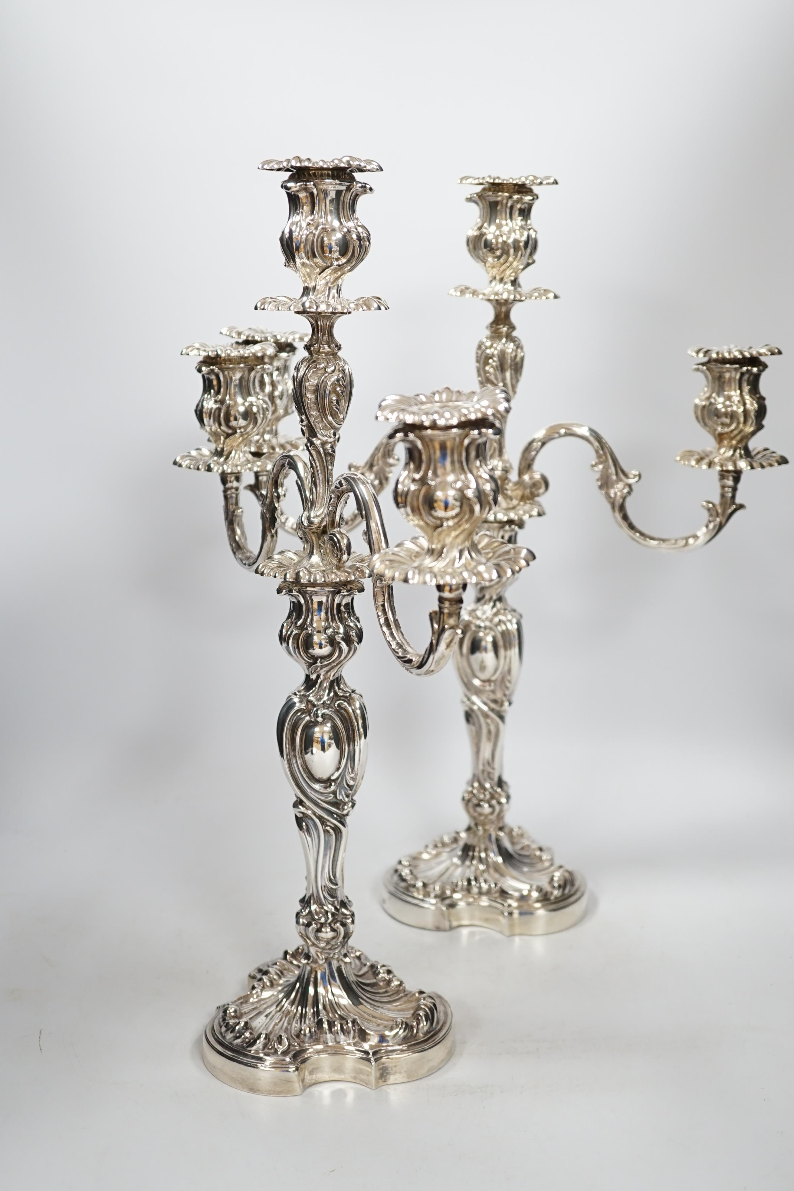 A good pair of late Victorian Elkington & Co. silver twin branch, three light candelabra